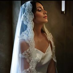 a woman wearing a wedding veil and looking off into the distance