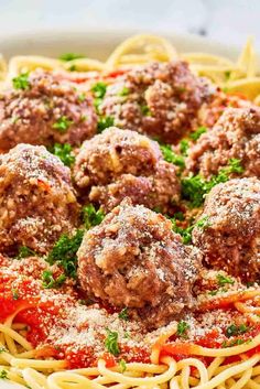 spaghetti with meatballs and parmesan cheese on top