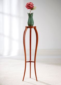 a wooden stand with a flower in it