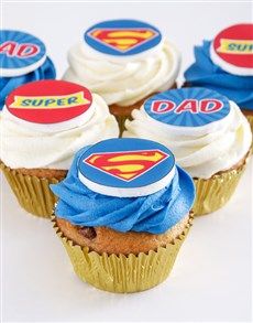 some cupcakes with icing on them are decorated like superman's and dad's logos