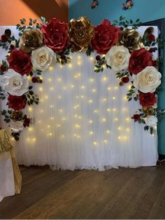 the backdrop is decorated with red, white and gold flowers on it's side