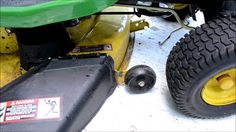 a lawn mower sitting on the ground next to some tires