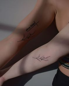 two women with matching tattoos on their arms