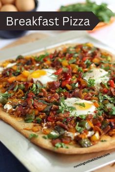 a breakfast pizza with eggs and bacon on it is sitting on a white platter