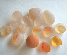 several different colored candies on a white surface