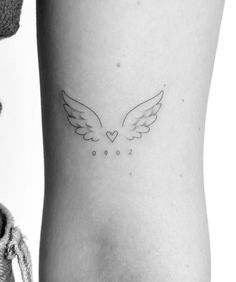 a woman's leg with a small tattoo on the side of her arm and an angel