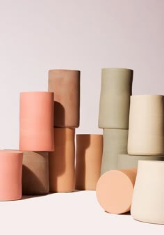 several different colored vases stacked on top of each other