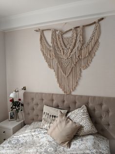 a bedroom with a large bed and decorative wall hangings