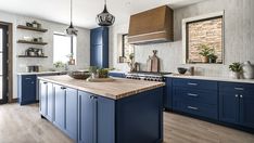 a large kitchen with blue cabinets and wooden counter tops, along with an island in the middle