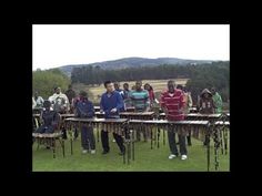 a group of people standing around musical instruments