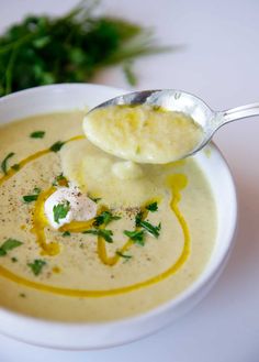 a spoon with some food in it on a plate