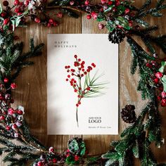 a christmas card surrounded by pine cones and berries