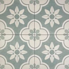 a tile floor with white and gray flowers on the tiles in different shapes, sizes and colors