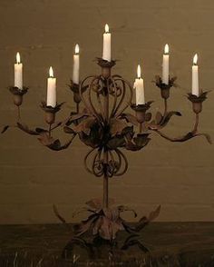 a chandelier with seven lit candles on it