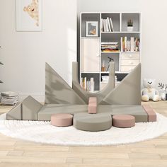 a living room filled with furniture and bookshelves next to a book shelf on top of a hard wood floor