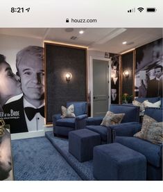 a living room with blue couches and pictures on the wall