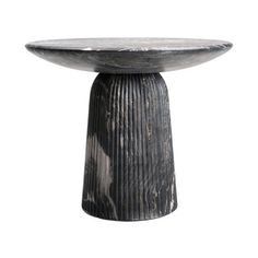 a black and white marble pedestal on a white background, with the top turned to look like it is made out of wood