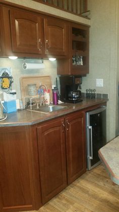 a kitchen with wooden cabinets and stainless steel appliances