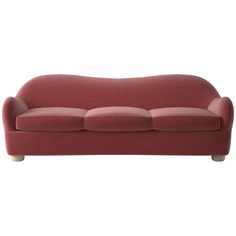 a red couch sitting on top of a white floor