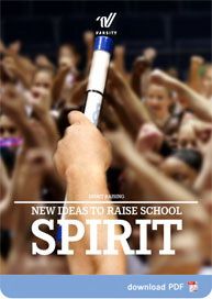 a hand holding up a pen with the words new ideas to raise school spirit