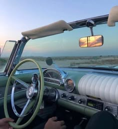 the interior of an old car with dashboard, steering wheel and dash light on it