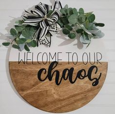 a wooden sign that says welcome to our chaos