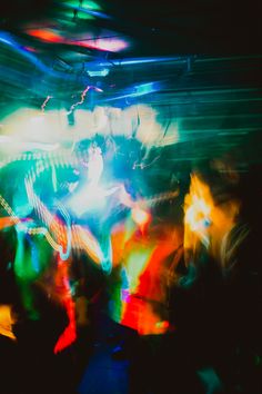 blurry photograph of people dancing in a club