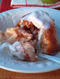 a white plate topped with a pastry covered in icing