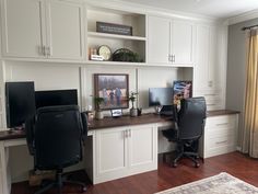 a home office with two computer screens on the desk