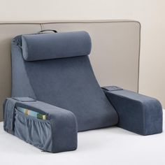 a blue reclining chair sitting on top of a white floor next to a wall