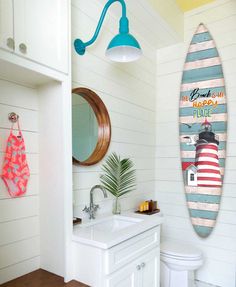 a bathroom with a surfboard hanging on the wall