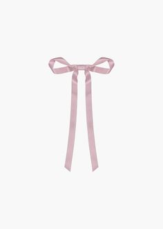 a pink ribbon tied on top of a white wall