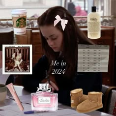 a woman sitting at a table in front of a bottle of coffee and other items