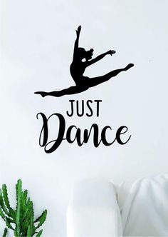 a wall decal that says just dance with a ballerina in the air on it