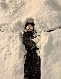 a person is standing in the snow with their feet up and his head turned to the side