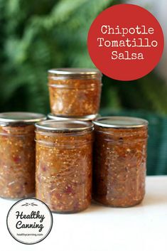 four jars of chipotle tomato salsa sitting on a table with the words chipotle tomato salsa above them