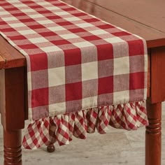 a red and white checkered table cloth on a wooden table