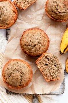 banana muffins are sitting on top of a paper towel next to some bananas