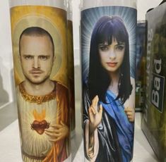 three cups with pictures of people painted on them, one has a woman and the other is a man