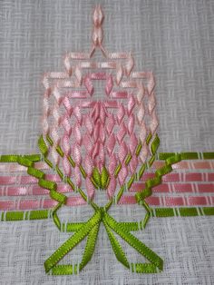 a close up of a piece of cloth with flowers on it and green stems in the center