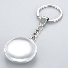 a metal key chain with a silver ball on it's end and a white background