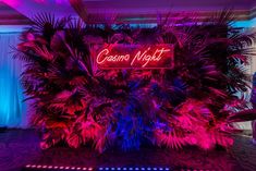 the neon sign is lit up in pink and blue lights for a night club party