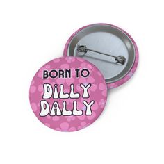 a pink button with the words born to dillly daily on it and polka dots