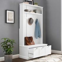 a white coat rack with two coats hanging on it's sides and a purse sitting on the top shelf