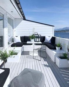 an outdoor living area with black and white furniture