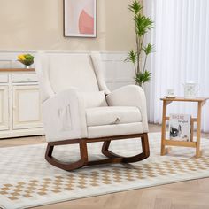 a white rocking chair sitting on top of a rug