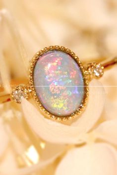 This stunning shimmery stone is opal. This opal ring can go with every outfit #opalring #gemstonering #engagementring #goldring Gold Opal Ring With Spiritual Style, Spiritual Yellow Gold Oval Opal Ring, Spiritual Gold Round Opal Ring, Gold Spiritual Opal Ring, Spiritual Gold Opal Ring, Heirloom Gold Opal Gemstone Ring, Heirloom Opal Rings In Gold, Heirloom Gold Opal Promise Ring, Gold Opal Ring Fine Jewelry