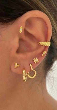 a woman's ear with three different types of piercings on the top and bottom