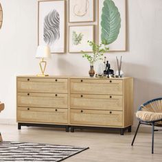 a living room filled with furniture and pictures hanging on the wall above it's wooden dresser