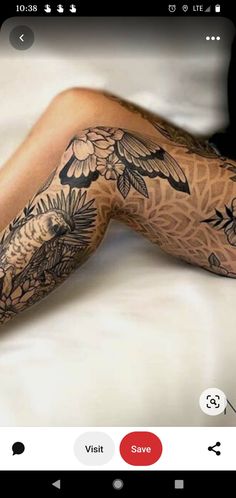 an image of a person with tattoos on their legs and arms, sitting in bed